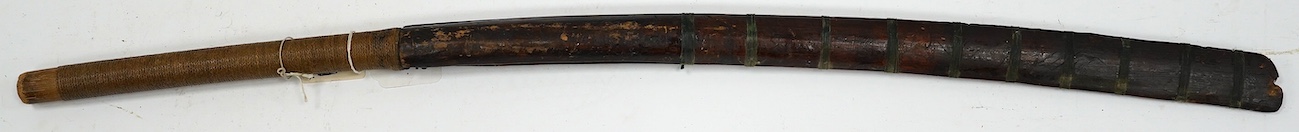 A Burmese sword Dha, curved single edge blade, hilt bound with platted rattan, in its wooden scabbard, blade 60cm. Condition - fair